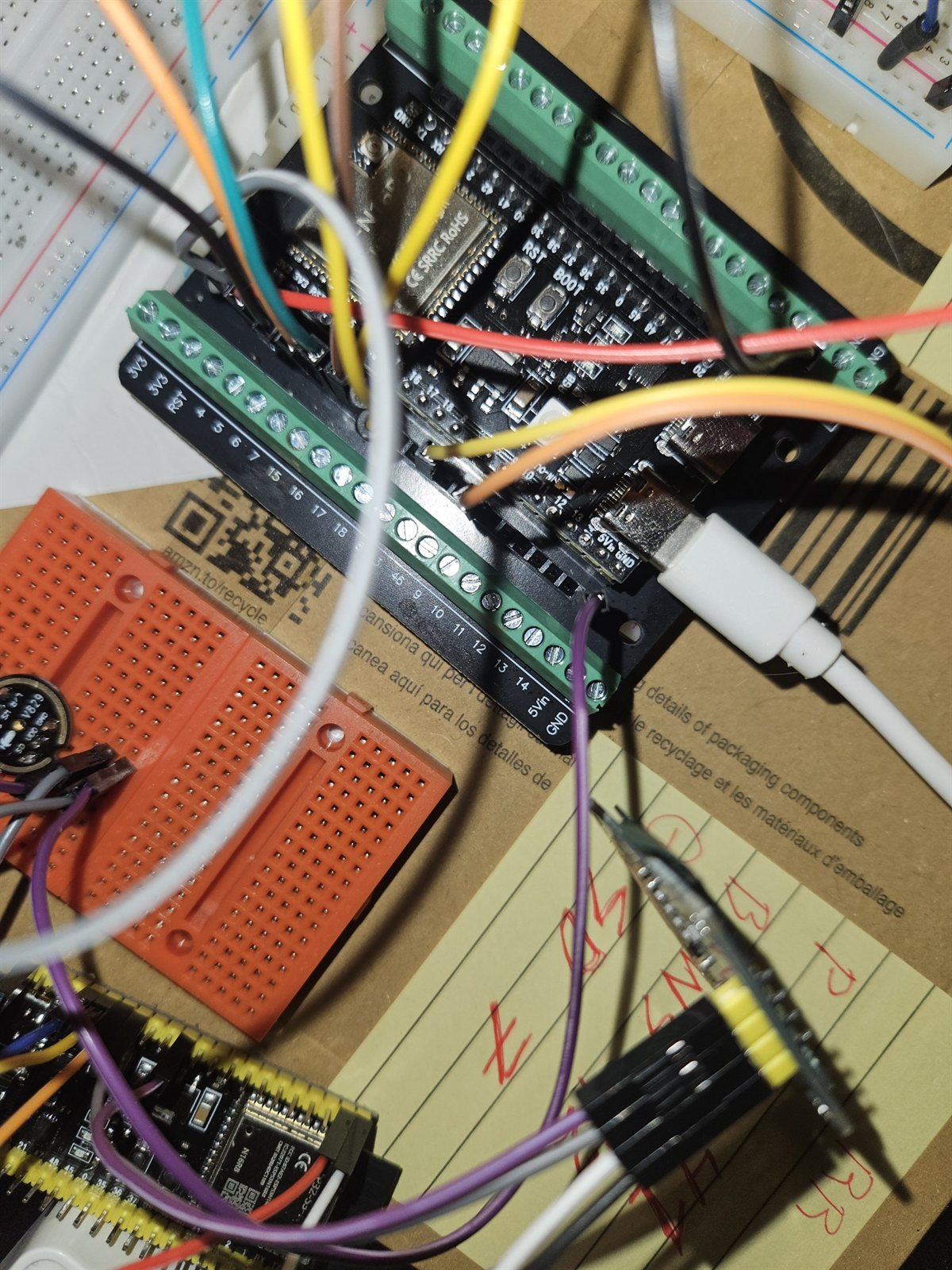 ESP32-S3 devkit in a green screw-terminal carrier with jumper wires